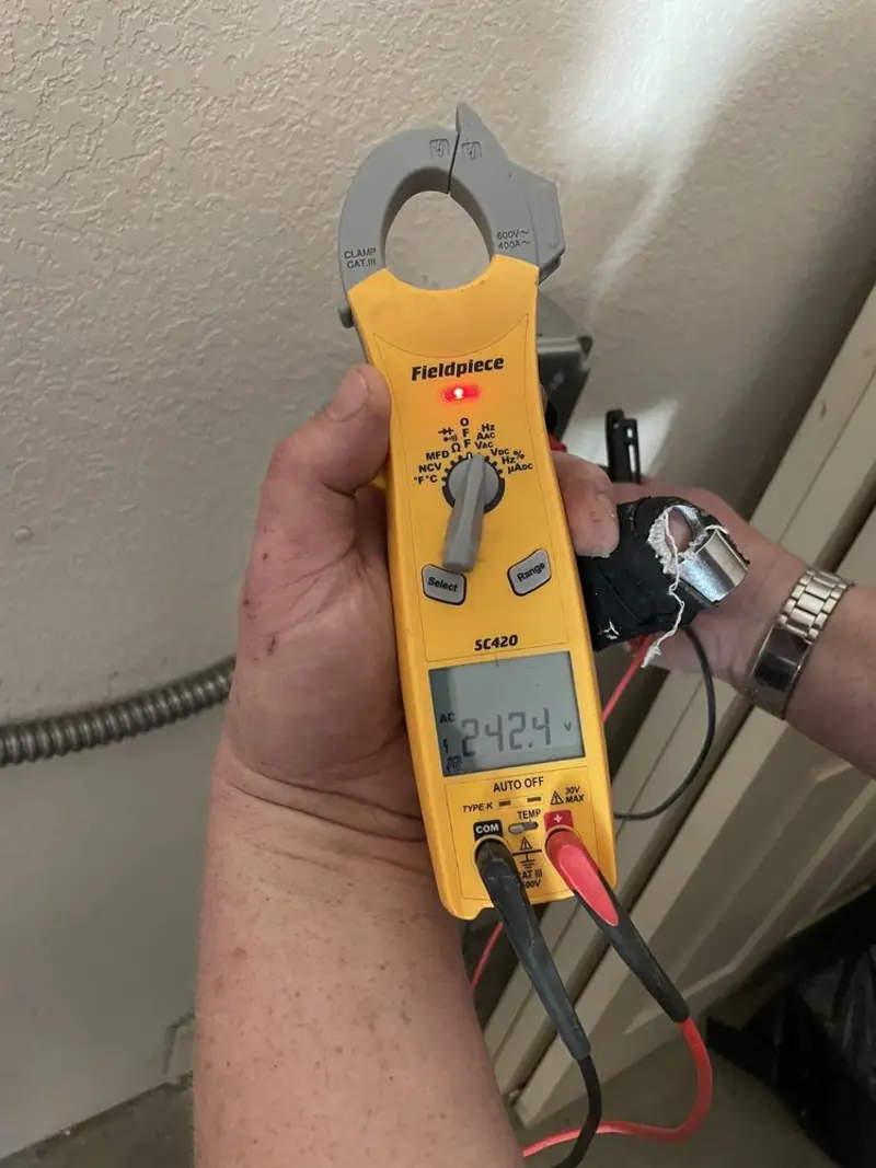 Voltage testing with clamp meter during Outlet Installation in Rumford